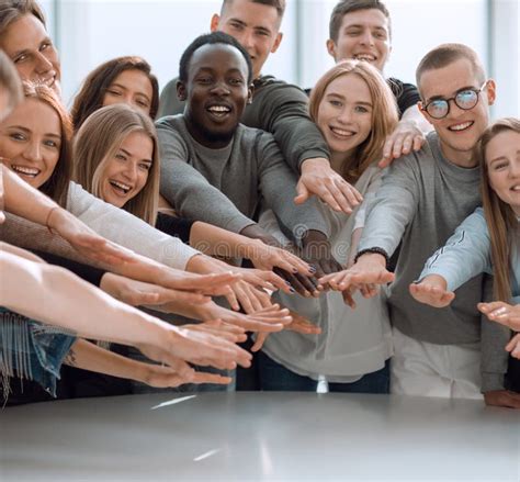 Group Of Smiling Young People Joining Their Hands Stock Image Image