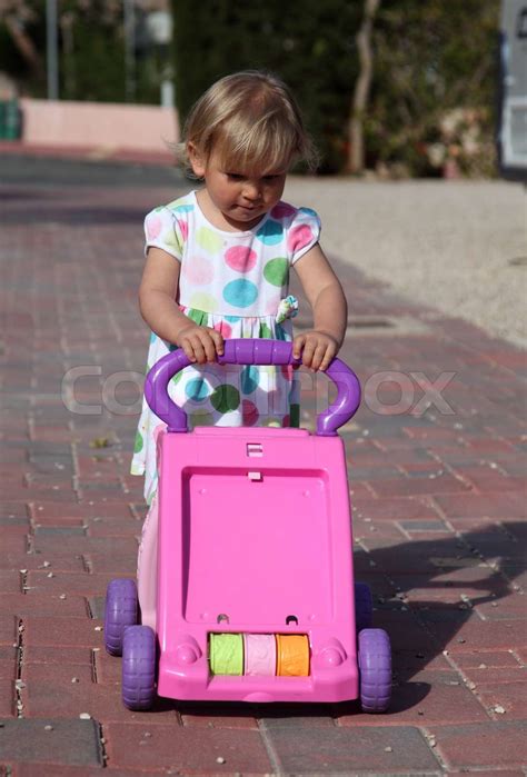 Toddler Girl Pushing Toy Trolley Stock Image Colourbox