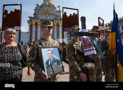 Honor guard soldiers hold a portrait of the deceased Sergii Ilnitskiy