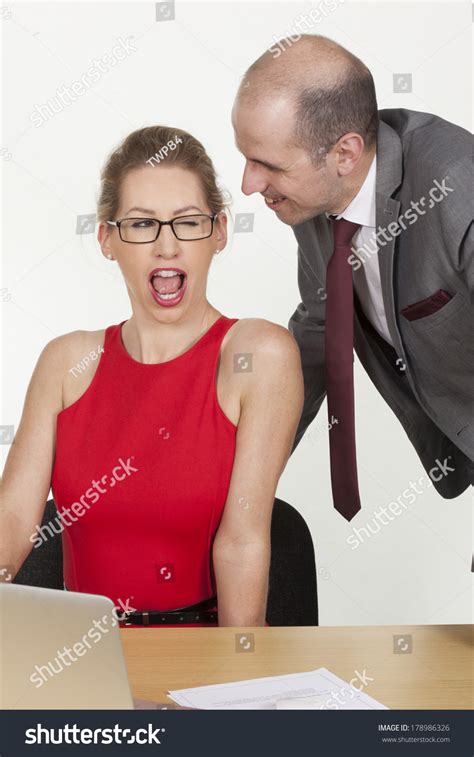 sexy affair in the office as a provocative secretary or colleague winks at her boss as he leans