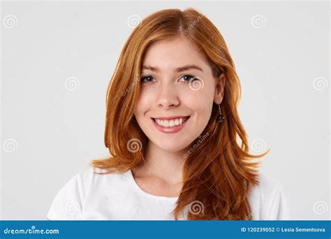 Studio Shot Of Pleasant Looking Caucasian Female With Gentle Smile