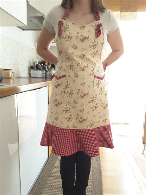 A Woman Standing In A Kitchen Wearing An Apron And Black Tights With Her Hands On Her Hips