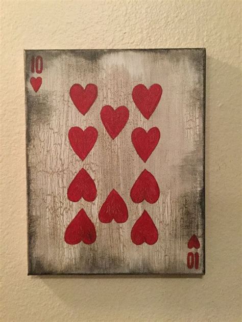 A Playing Card With Hearts Painted On The Front And Back Of It Hanging