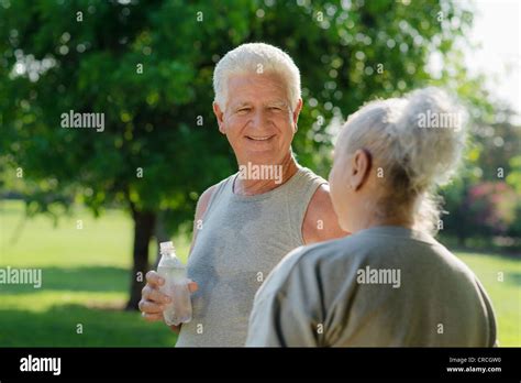 Senior People Old Man And Woman Talking And Drinking Water After