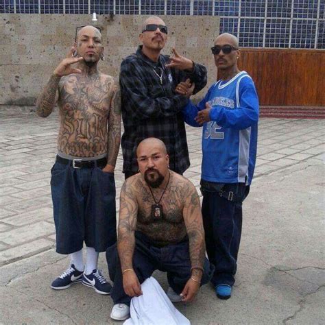 Three Men Standing Next To Each Other With Tattoos On Their Arms And