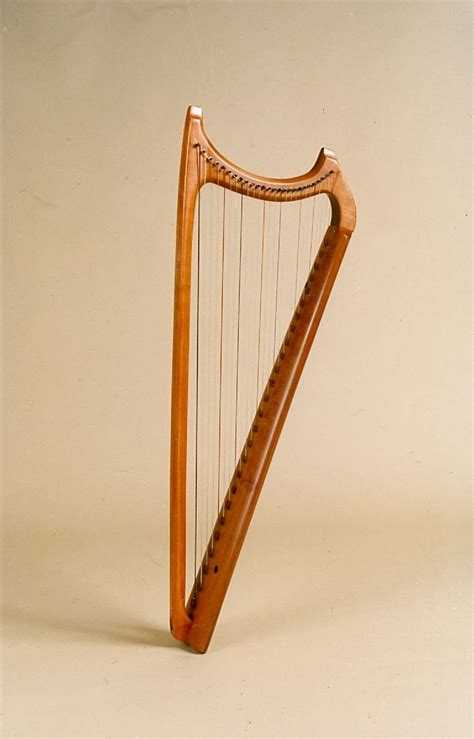 An Old Wooden Harp With Strings On A White Background