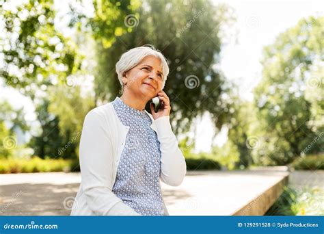 Happy Senior Woman Calling On Smartphone In Summer Stock Photo Image
