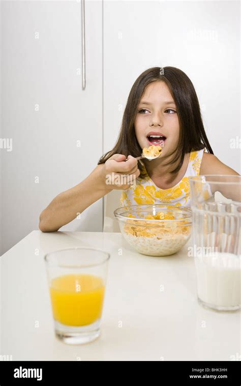Girl Eating Cereal For Breakfast Stock Photo Alamy