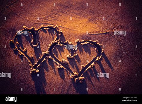 Two Hearts Drawn In The Sand Stock Photo Alamy