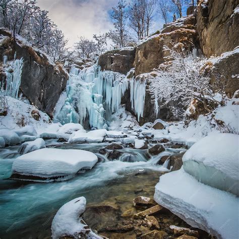 Premium AI Image | Winter Wonderland Icy Waterfalls and SnowClad Rocks