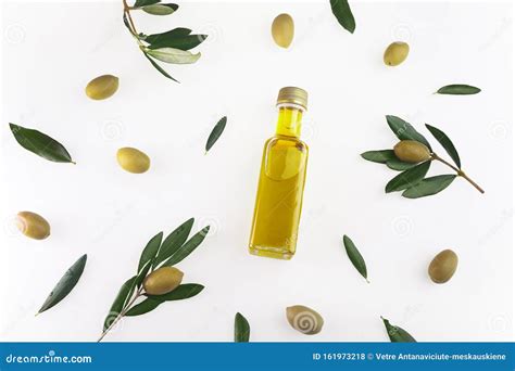 Olive Oil In A Glass Bottle And Green Olives On White Background Top