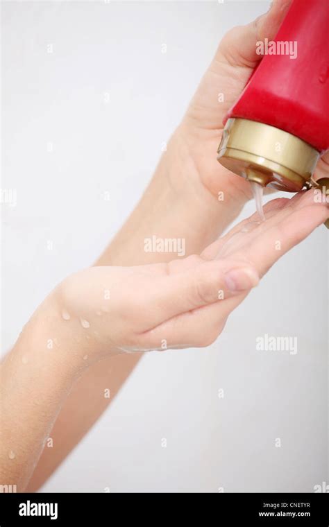 Liquid Gel Soap Pouring From Bottle Into A Womans Hand Stock Photo Alamy