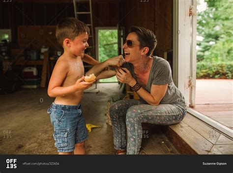 Mother And Son Play Fighting In A Garage Stock Photo OFFSET