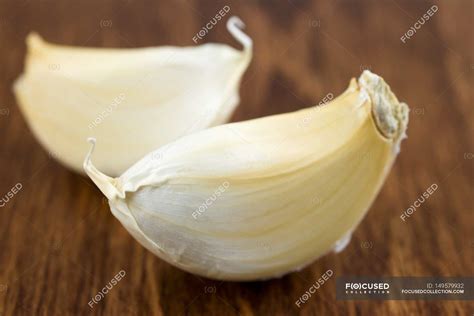 Two Cloves Of Garlic — Delicious Wooden Stock Photo 149579932