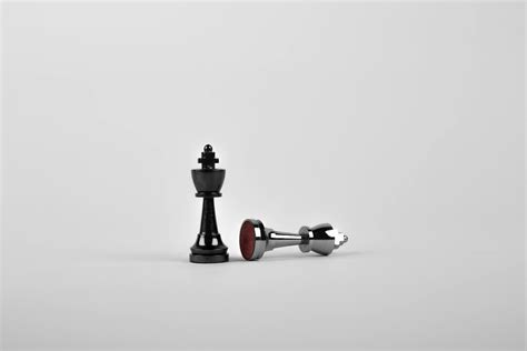 Two Silver Chess Pieces On White Surface · Free Stock Photo