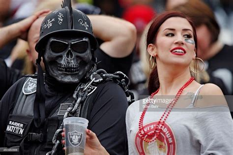 An Oakland Raiders Fan And A San Francisco 49ers Fan Watch Their