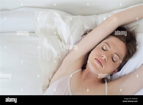 Woman Lying In Bed Stretching Arms Over Head Stock Photo Alamy