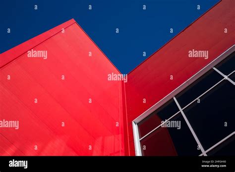 Low Angle View Of Modern Office Building With Red Facade Stock Photo