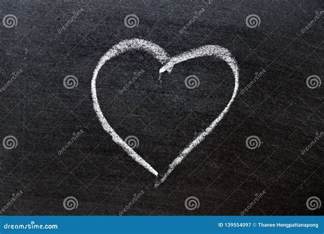 White Coloe Chalk Drawing As Heart Shape On Blackboard Background With