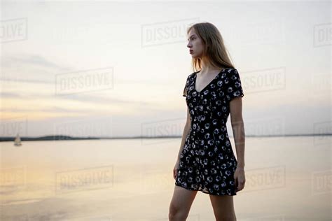 Woman Wearing Black Dress By Sea Stock Photo Dissolve