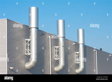 Three Chimneys On An Industrial Building Stock Photo Alamy