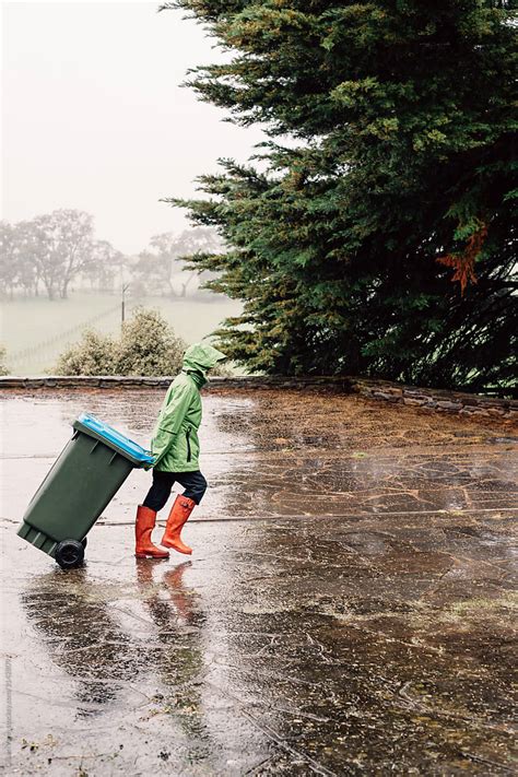 Tween Girl Doing Chores In The Rain Taking The Bin Out By Stocksy Contributor Gillian Vann
