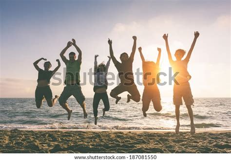 Multiracial Group People Jumping Beach Backlight Stock Photo 187081550