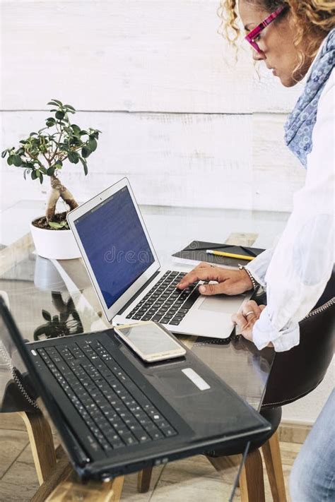 Woman Standing And Operating Laptop Keyboard While Doing Office Work On
