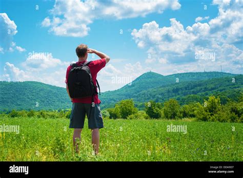 Hiker Man Standing On A Field Looking Far Away Stock Photo 59848579