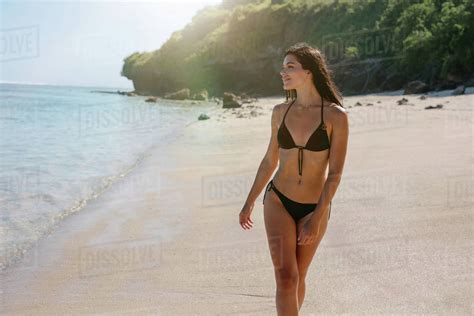 Shot Of Smiling Young Female Bikini Model Walking On The Sea Shore Beautiful Young Enjoying
