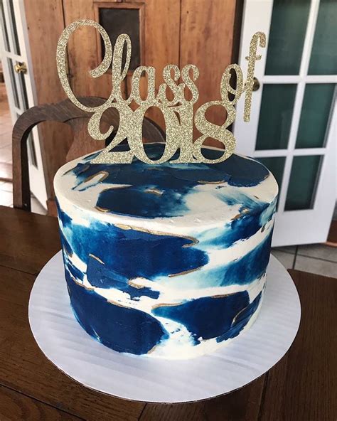 Choosing a graduation cake design is not an easy task. Navy and gold graduation party watercolor cake with gold luster dust | Graduation party cake ...