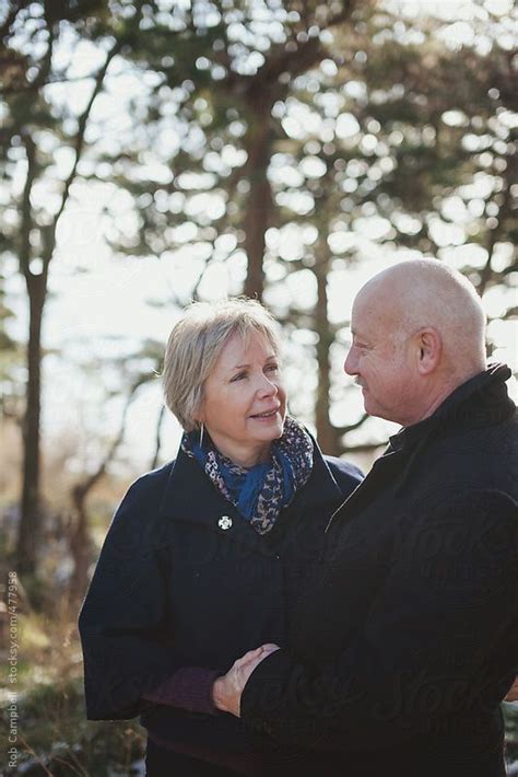 Happy Older Middle Aged Couple Fifties Looking At Each Other Smiling Outside In Winter By