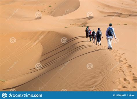 Group Of People Walking On Sand Dunes Editorial Photo Image Of Maroc