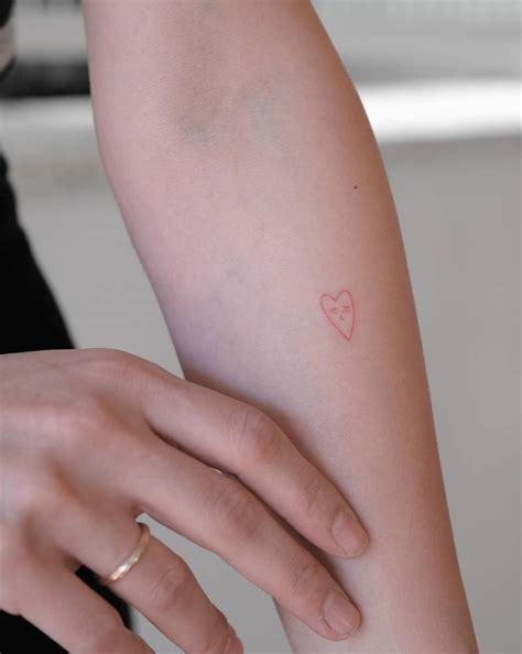 Minimalistic Style Red Heart Tattoo Placed On The Inner