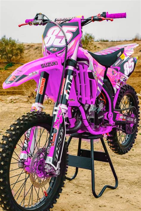 A Pink Dirt Bike Parked On Top Of A Metal Stand