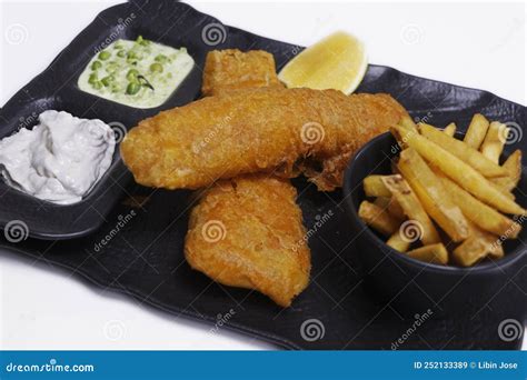 Fish And Chips Plate With Battered Fried Cod Fish And French Fries With