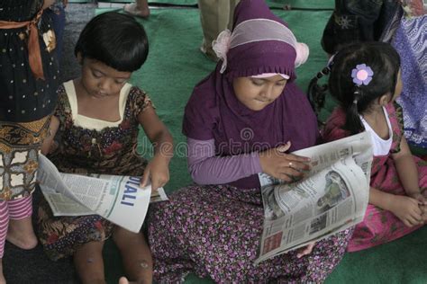 Children Reading A Newspaper On A National Press Editorial Photography