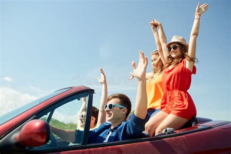 Happy Friends Driving In Cabriolet Car At Country Stock Photo Image