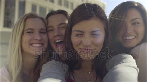 Closeup Of Carefree Teen Girls Making Funny Faces And Smiling For