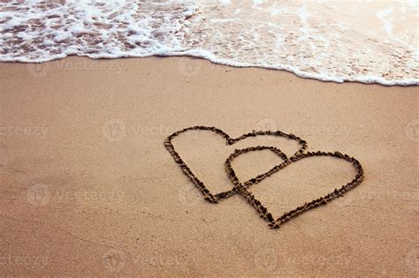 Two Hearts Drawn In Sand On A Beach 1253017 Stock Photo At Vecteezy