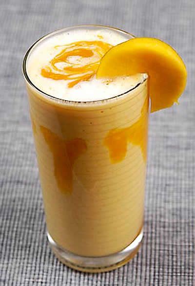 A Glass Filled With Orange Juice And Topped With A Slice Of Lemon On