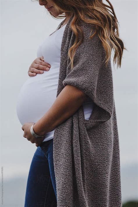 Beautiful Young Mixed Race Pregnant Woman Standing Near Ocean By Stocksy Contributor Rob And