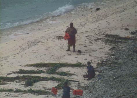 these guys were rescued from a deserted island by writing help in the sand