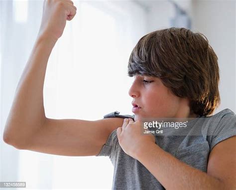 Adolescent Boy Flexing Muscle Stock Fotos Und Bilder Getty Images
