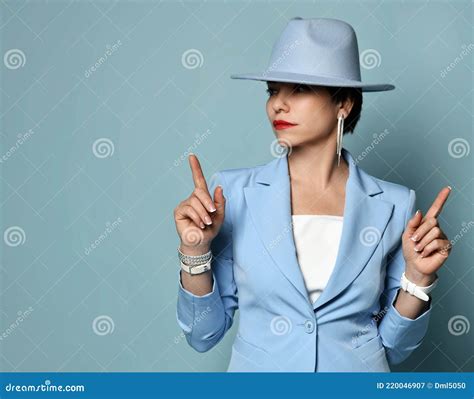 Attractive Confident Short Haired Brunette Woman In Blue Business Smart Casual Suit And Hat