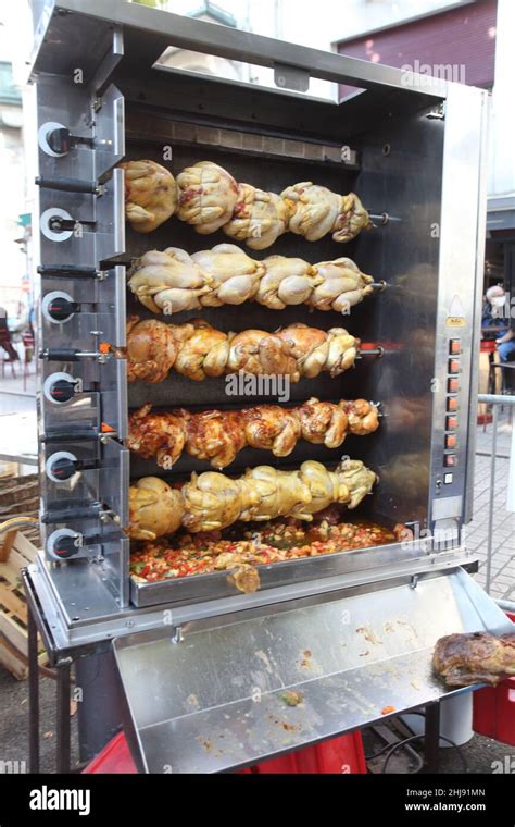 Typical French Rotisserie Spit Roasting Chickens At Lunchtime In St