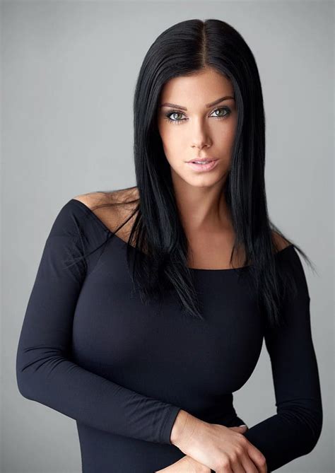 A Woman With Long Black Hair Posing For The Camera