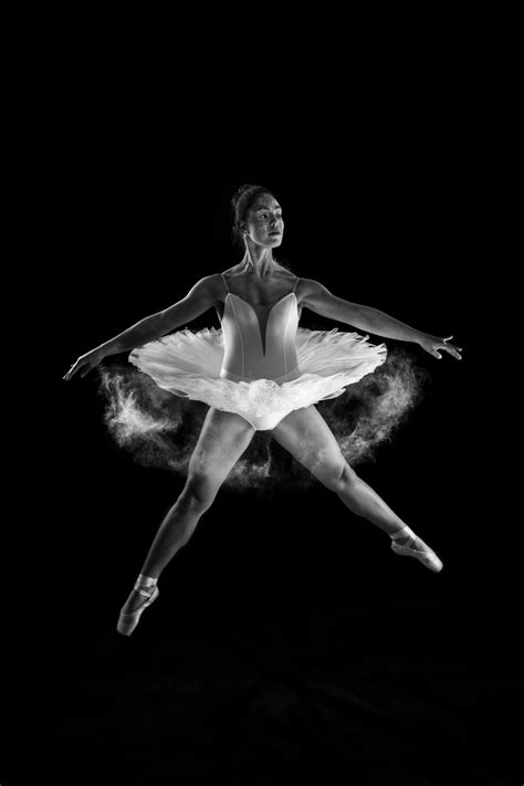Black And White Shot Of Ballet Dancer In White Tutu Jumping In