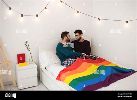 Gay Men Couple Having Tender Moments Sitting On Bed At Home Homosexual Love And Relationship