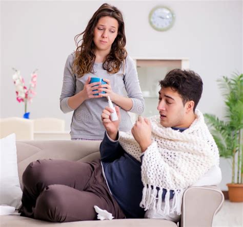 Wife Caring For Sick Husband At Home Stock Photo Image Of Fever